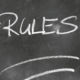 "Rules" written in chalk on a blackboard